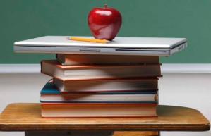 apple-on-books-on-teachers-desktop